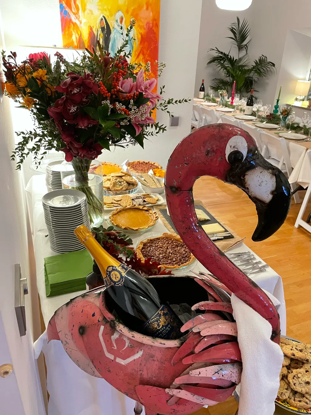 Table with food. Metal flamingo wine bottle cooler.