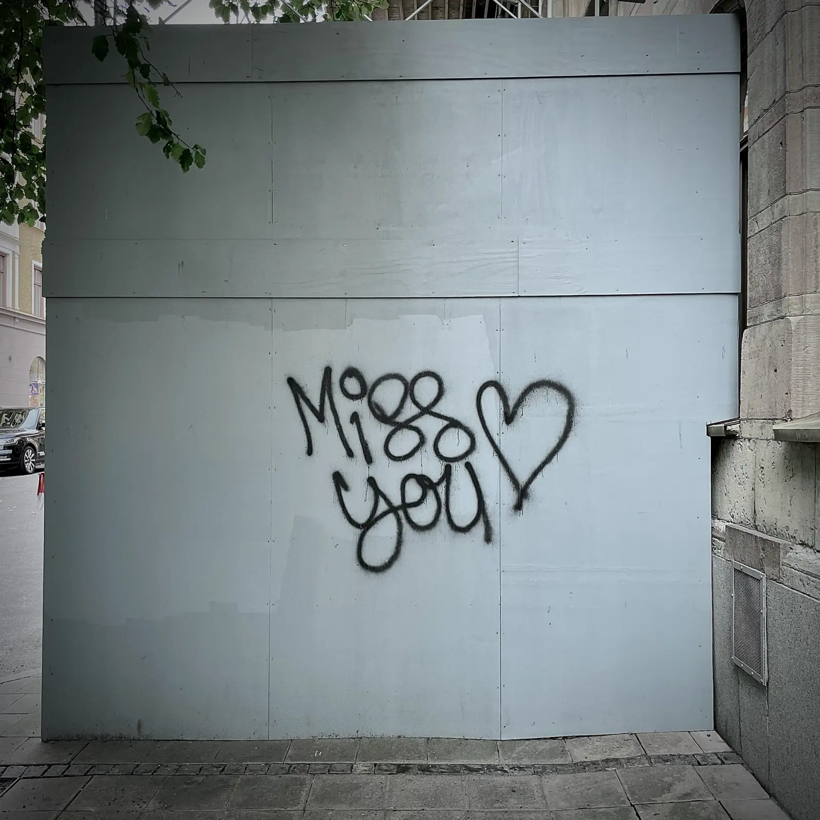 Graffito of text miss you on a construction wall in Stockholm