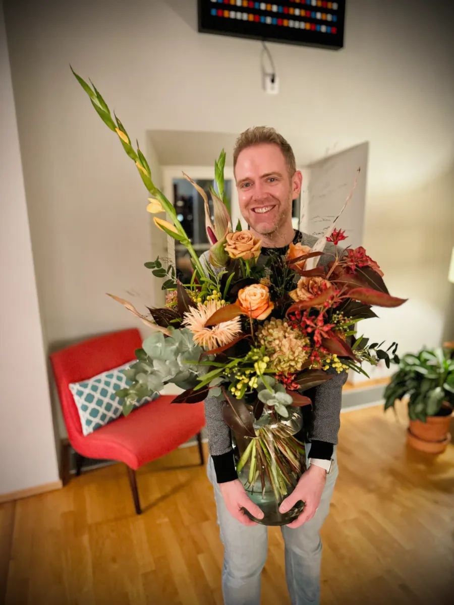 Arthur holding large vase of flowers